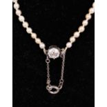 A PEARL NECKLACE with diamond clasp.