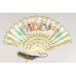 A FRENCH IVORY AND PAPER FAN, painted with classical figures in a garden setting, 17ins open, in a