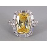 A GOOD LARGE CITRINE AND ZIRON RING, set in silver.