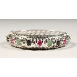 A SILVER, SAPPHIRE, RUBY AND EMERALD SET BRACELET.