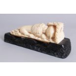 AN ORIENTAL CARVED IVORY TUSK GROUP, a lion attacking a bear. 7.5ins long, on a wooden base.