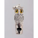 A SILVER OWL WHISTLE.