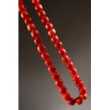 A STRING OF LARGE CORAL BEADS.