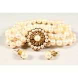 A THREE-ROW PEARL BRACELET, with pearl and diamond gold clasp with pearl studs.