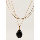 A GOOD CHAIN AND DROP PEAR SHAPED PENDANT AND THREE DELICATE GOLD CHAINS.