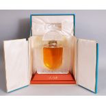 A LALIQUE PERFUME BOTTLE, of large size, with contents, in a presentation box. Bottle 10ins high.