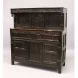 A 17TH CENTURY STYLE OAK COURT CUPBOARD, with carved frieze, three carved panelled doors, the base