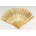 A FRENCH HORN AND PAPER FAN, painted with gilt decoration. 13ins open.