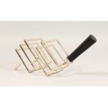 A CHRISTOPHER DRESSER DESIGN FOUR DIVISION TOAST RACK, with ebony handle.