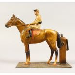 A PAINTED METAL FIGURE OF A JOCKEY ON A HORSE, as a lighter. 6.5ins high.