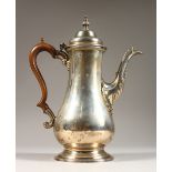 A LARGE GEORGE III PLAIN PEAR SHAPED COFFEE POT with wooden handle. 11ins high. London 1765. Maker