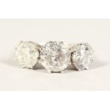 AN IMPRESSIVE 18CT WHITE GOLD THREE STONE DIAMOND RING of 7cts.