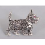 A SILVER SCOTTIE DOG BROOCH.