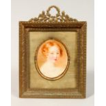 PORTRAIT HEAD AND SHOULDERS OF A YOUNG CHILD in a gilt frame. Oval. 2ins x 1.5ins.