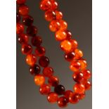 A LONG AMBER TYPE BEAD NECKLACE.