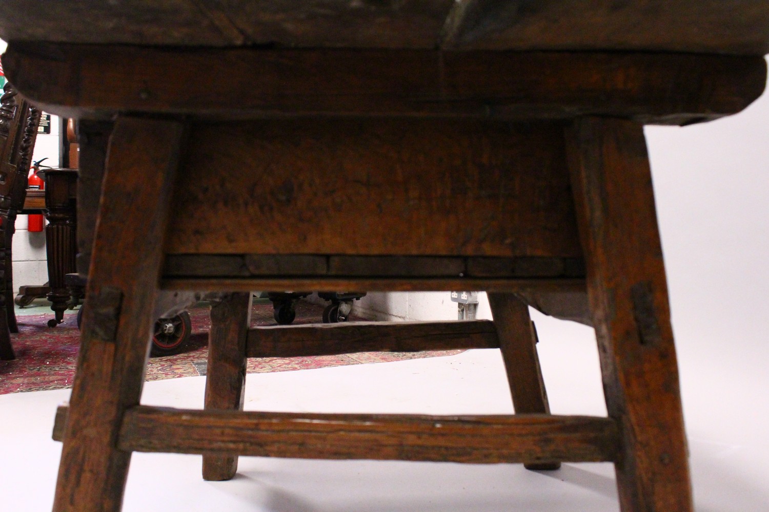 A 16TH CENTURY OAK RUSTIC LOW TABLE, with plank top over a drawer with carved decoration, a circular - Image 7 of 7