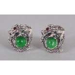 A PAIR OF SILVER , JADE AND RUBY CUFFLINKS.