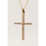 A 9CT GOLD DIAMOND SET CROSS, on a chain.