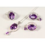 A SILVER AND AMETHYST THREE PIECE SET, PENDANT, RING AND EARRINGS.