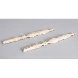 A PAIR OF ORIENTAL CARVED IVORY FAN HANDLES. 7.5ins long.