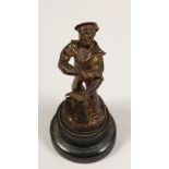 A BRONZE SAILOR on a circular base. 7ins high.