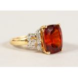 A 14CT YELLOW GOLD LARGE GARNET AND DIAMOND RING.