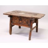 A 16TH CENTURY OAK RUSTIC LOW TABLE, with plank top over a drawer with carved decoration, a circular