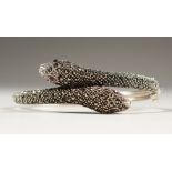 A SILVER AND MARCASITE SNAKE BRACELET, in a heart shaped box.