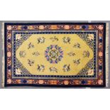 A CHINESE RUG, beige ground with a central motif and stylised floral sprays. 8ct 1ins x 5ft 2ins.