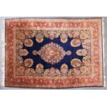 A GOOD LARGE PERSIAN CARPET, deep blue ground, with all-over stylised floral decoration, within a