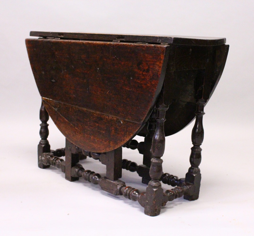 AN 18TH CENTURY OAK OVAL DROP LEAF GATE-LEG DINING TABLE, with baluster turned legs, and similar