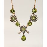 A 9CT GOLD, PERIDOT AND DIAMOND PENDANT AND CHAIN.