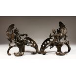 A PAIR OF BRONZE CHENETS of a boy and girl, on an acanthus scroll. 9ins high.