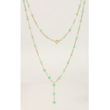 AN 18CT YELLOW GOLD AND EMERALD NECKLACE.