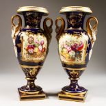 A GOOD PAIR OF DERBY TWO-HANDLED URN SHAPED VASES, blue ground painted with a panel of flowers, with