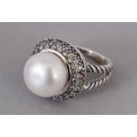 A LARGE PEARL SET RING, in silver.