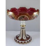 A BOHEMIAN OVERLAID CRANBERRY GLASS TAZZA WITH PAINTED FLORAL PANELS, APPROX. 22cm H, 20 cm DIA.