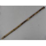 INTRICATELY CARVED ORIENTAL BAMBOO WALKING CANE WITH FLORAL AND GEOMETRIC PATTERN DECORATION,