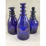 3 BRISTOL BLUE GLASS THREE RING DECANTERS, ONE WITH STOPPER