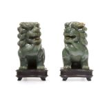 An opposing pair of carved serpentine foo dogs