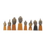 A collection of eight bronze buddha heads