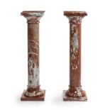 A pair of rouge marble pedestals