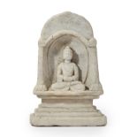 A carved stone seated figure of the Buddha