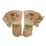 A pair of embroidered hide gauntlets