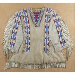 A framed Plains beaded war shirt