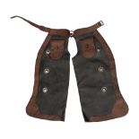 A pair of tooled leather western chaps with silver conchos