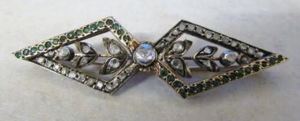 Tested as 9ct gold diamond and emerald brooch centre diamond 0.