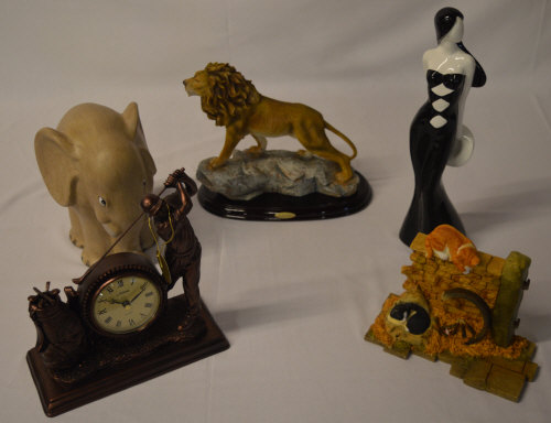 Various contemporary home decor including a Juliana golfing mantle clock and a resin figure of a