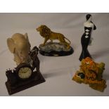 Various contemporary home decor including a Juliana golfing mantle clock and a resin figure of a