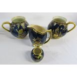 4 pieces of gilt and blue Carlton ware inc 3878 Devils Copse Jug & Fantasia jug (one jug has chips